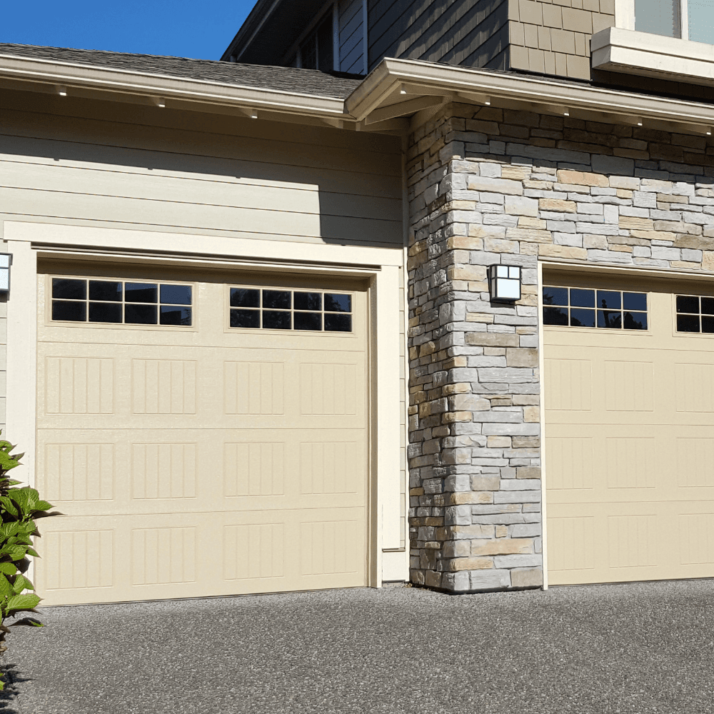 Luxury home with dual garage doors and stone column exterior