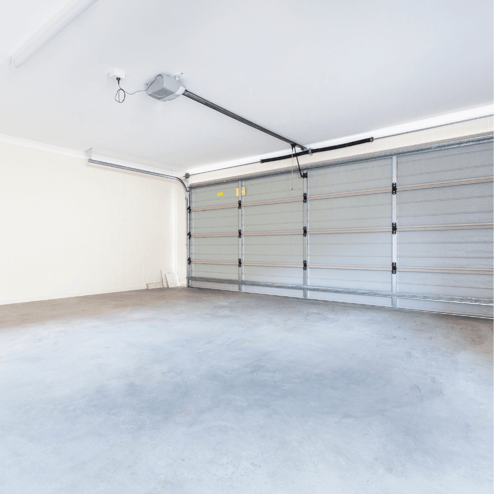 Interior view of garage door mechanical system showing tracks, springs, and operator