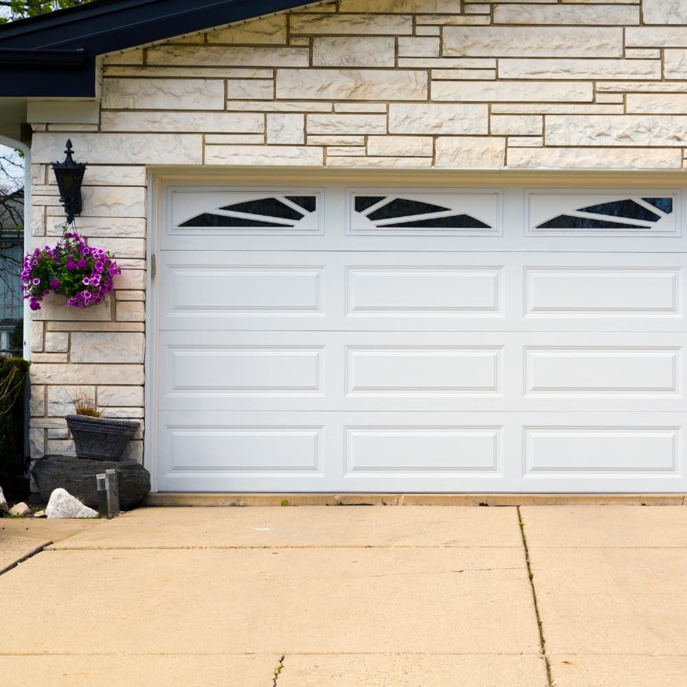 Residential home with garage doors and driveway